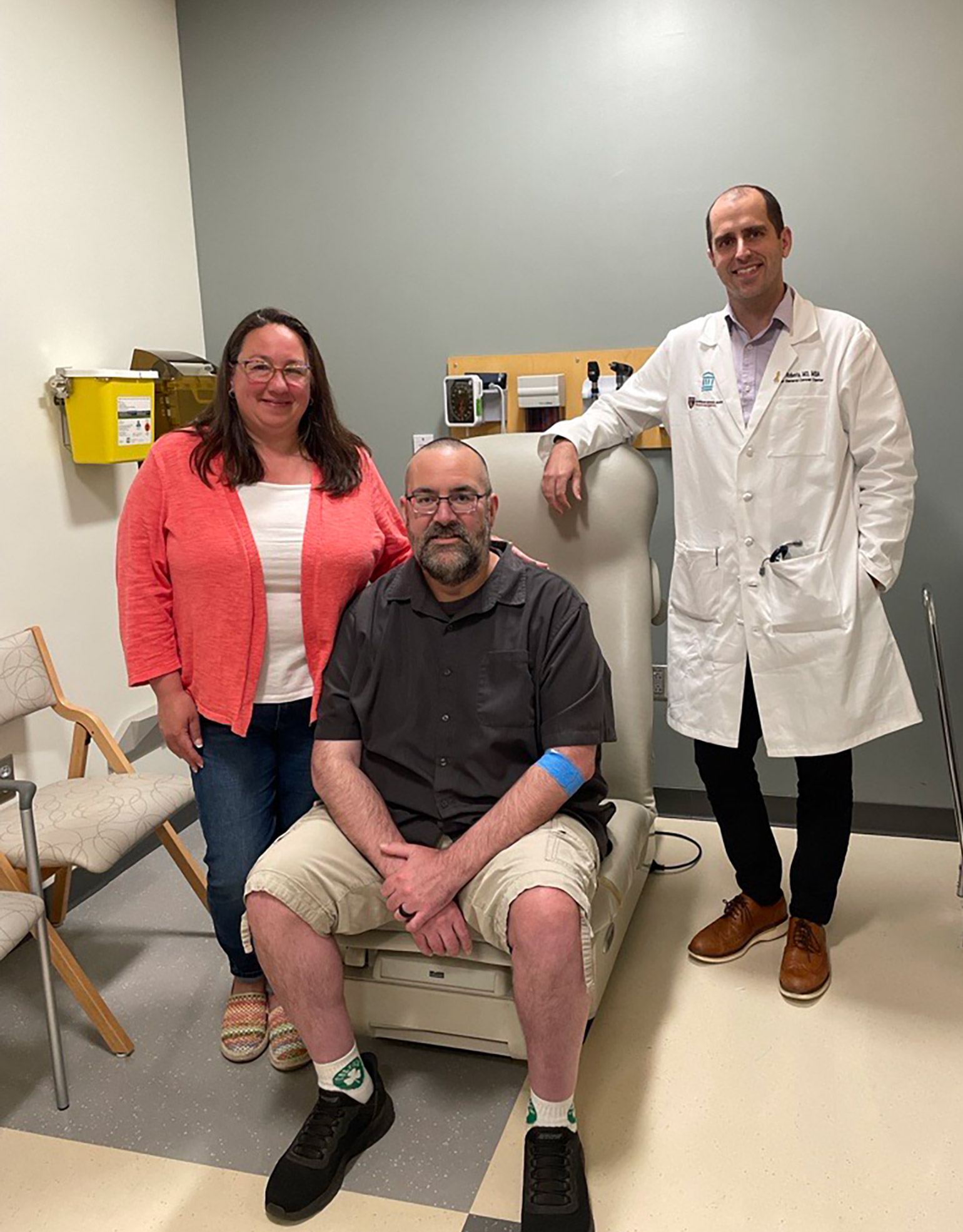 A patient and his wife are in a medical exam room with a doctor