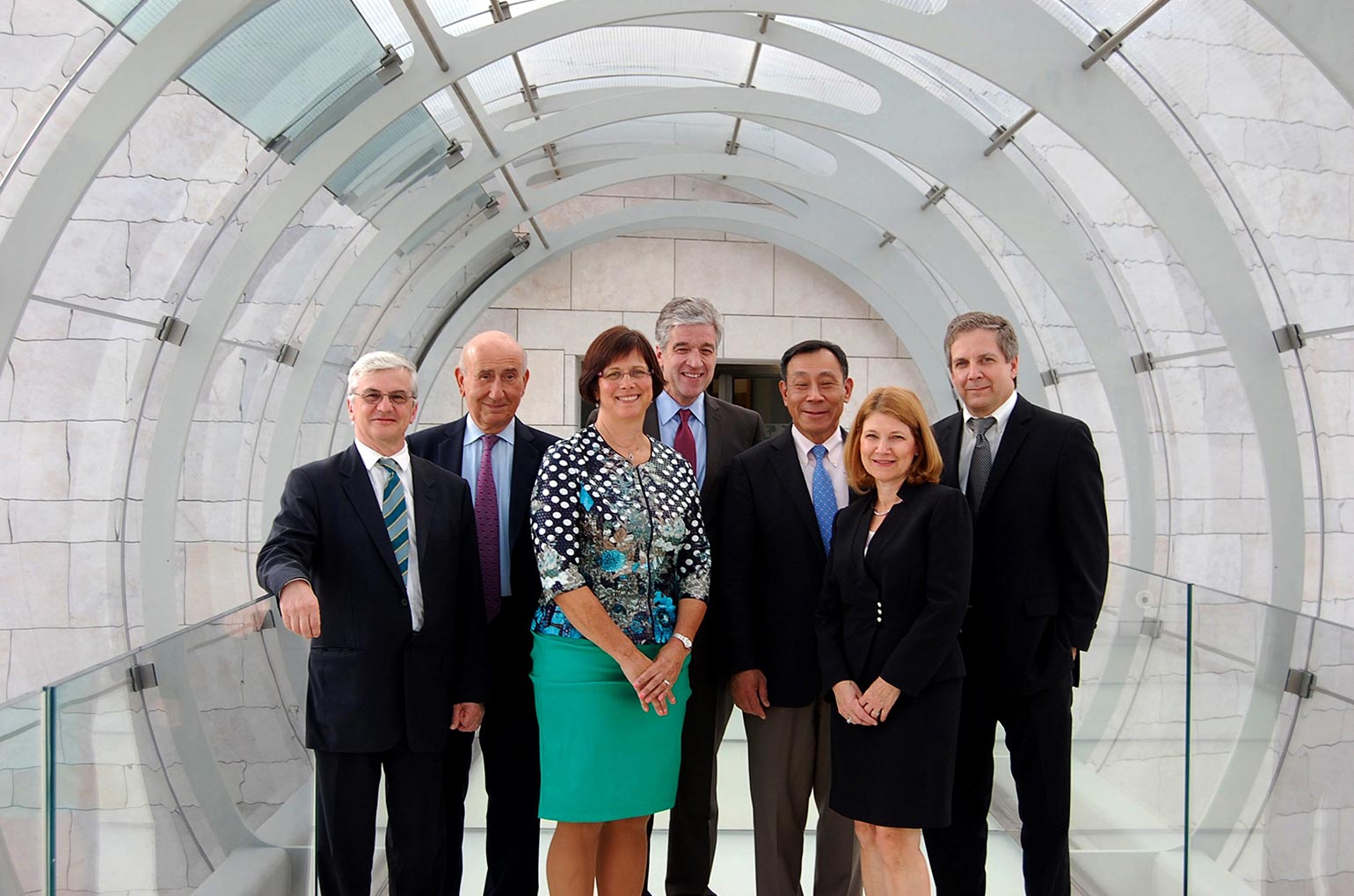 Seven people standing and smiling together for a group photo